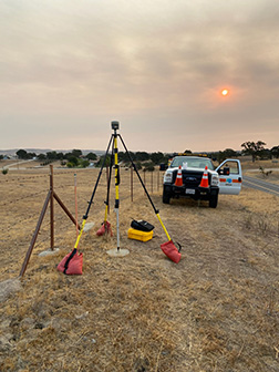 Caltrans set up for GPS on Benchmark with smoke from nearby fires filling the air